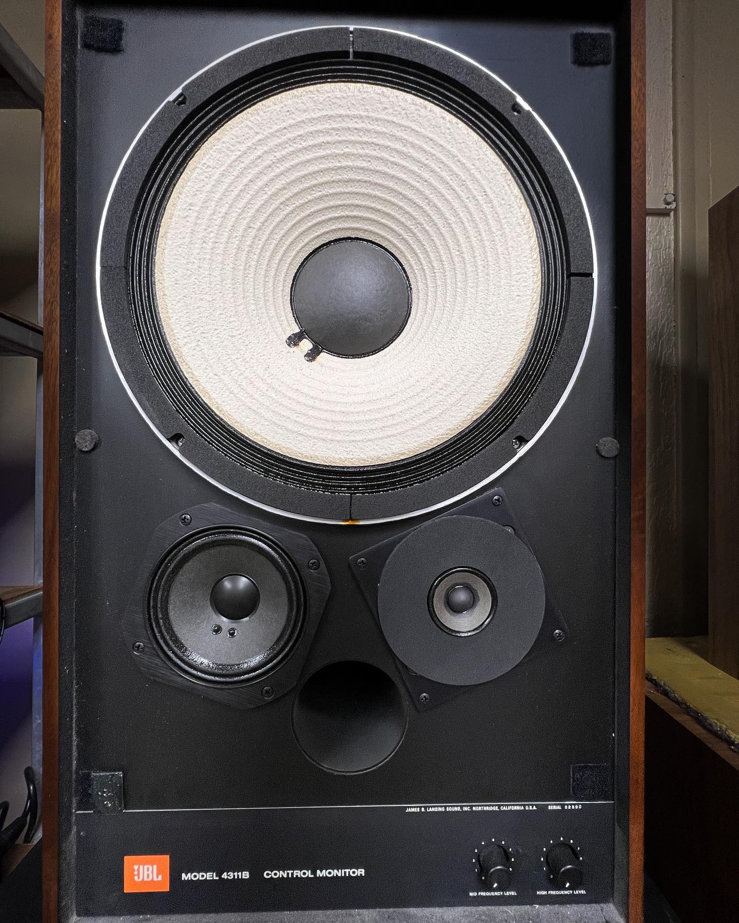 Restored JBL 4311B speaker with its large white woofer and exposed drivers