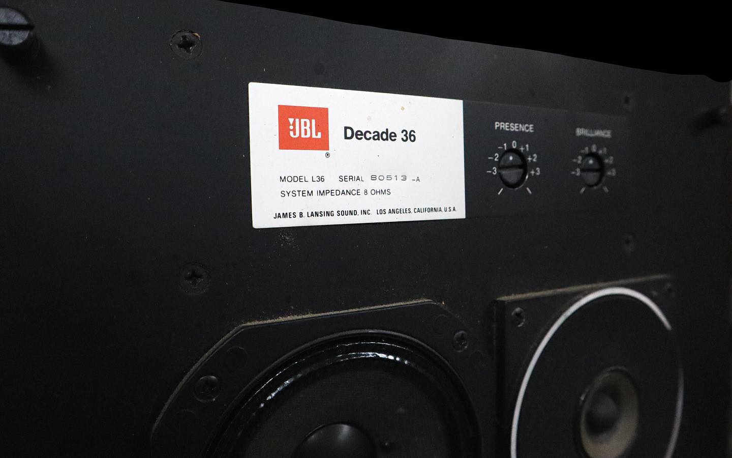 Close view of a vintage JBL Decade 36 speaker label, controls and drivers